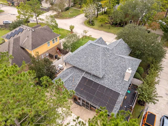 an aerial view of a house with a yard and trees