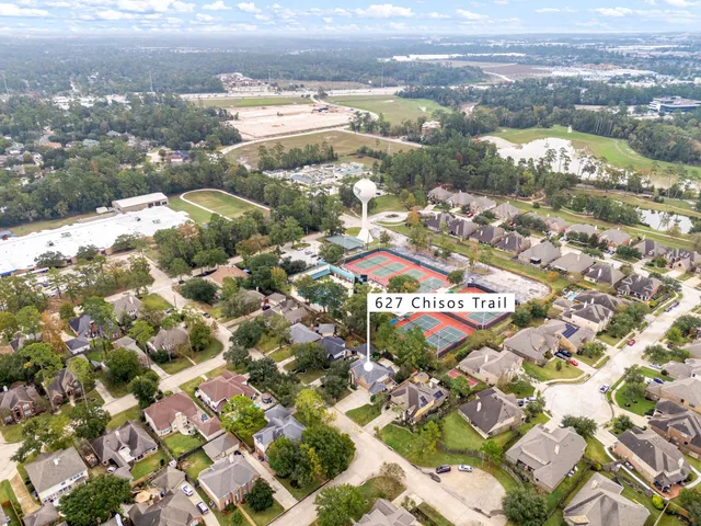an aerial view of residential houses with outdoor space and river