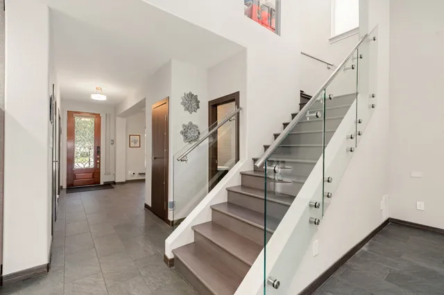 a view of entryway and hall with wooden floor