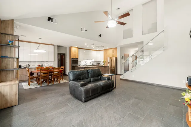 a living room with furniture and kitchen view