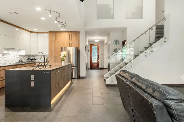 a living room with stainless steel appliances kitchen island granite countertop furniture