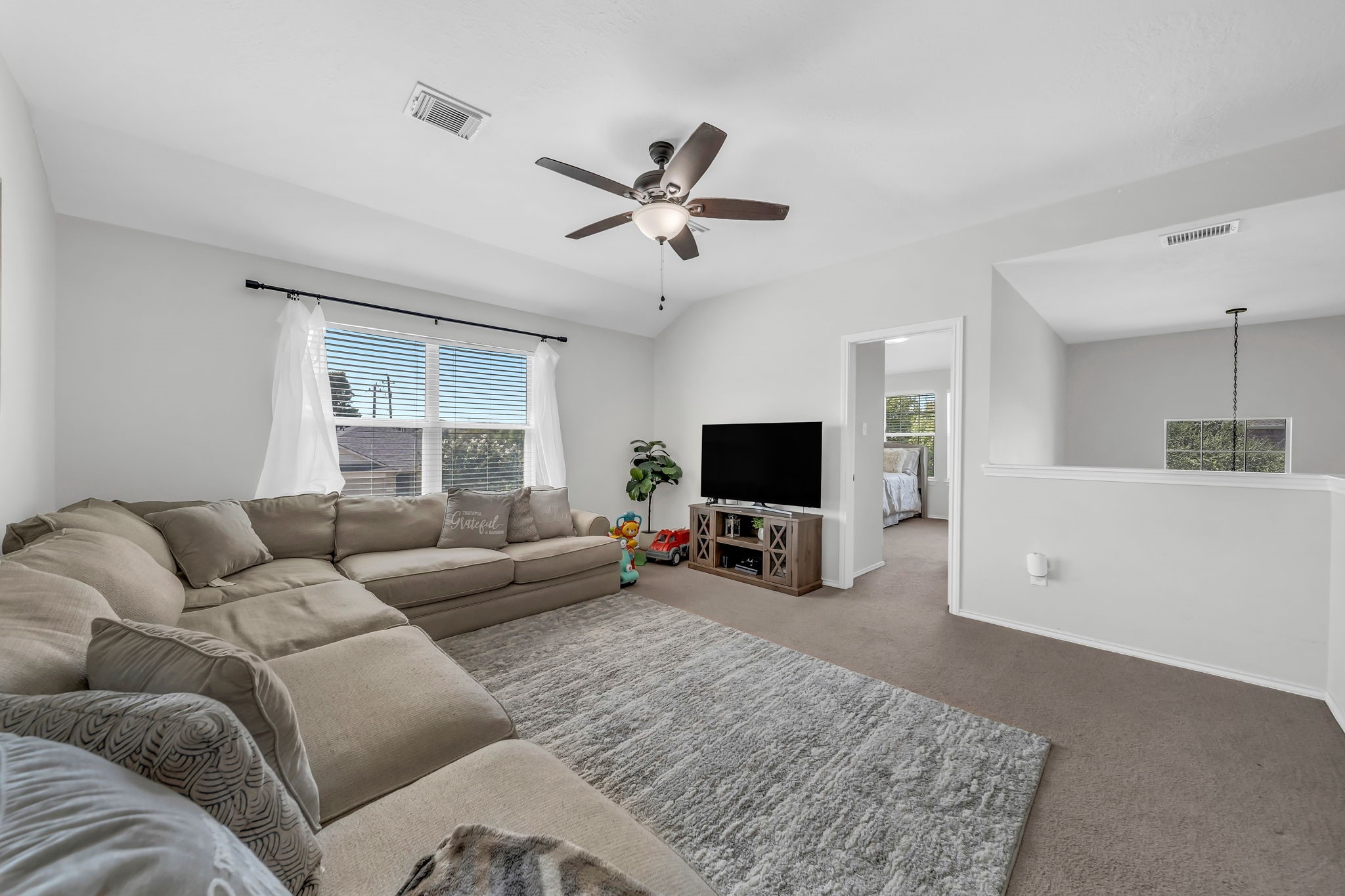 4502 Baron Road Baytown, TX 77521 - Photo 14 of 25 a living room with furniture and a flat screen tv