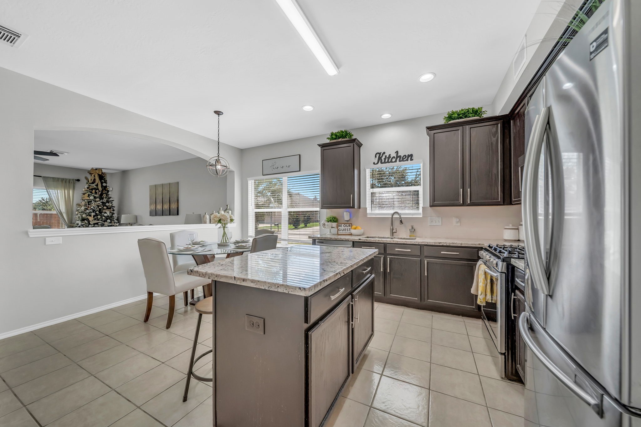 4502 Baron Road Baytown, TX 77521 - Photo 5 of 25 a kitchen with stainless steel appliances granite countertop a sink stove and refrigerator