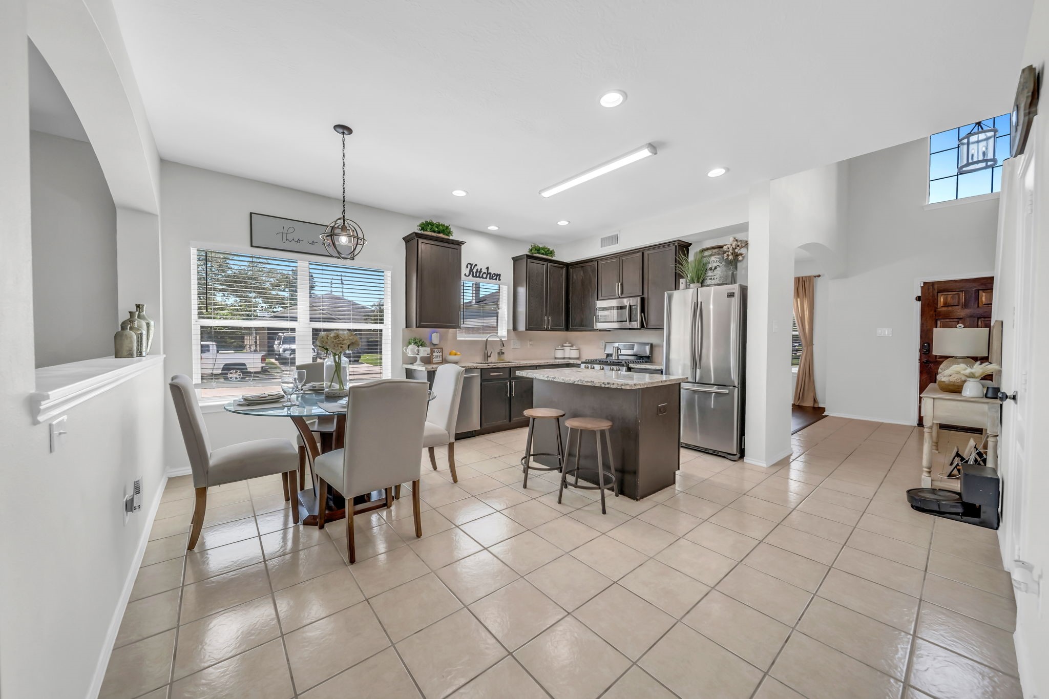 4502 Baron Road Baytown, TX 77521 - Photo 6 of 25 a kitchen with a sink a counter top space and stainless steel appliances