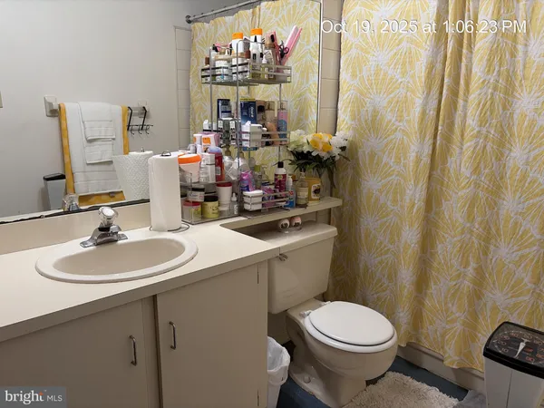 a bathroom with a sink mirror vanity and toilet