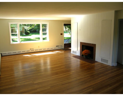 34 Webster Road Lexington, MA 02421 - Photo 3 of 12 a view of empty room with wooden floor and fireplace