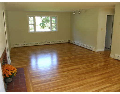 34 Webster Road Lexington, MA 02421 - Photo 5 of 12 an empty room with wooden floor and windows