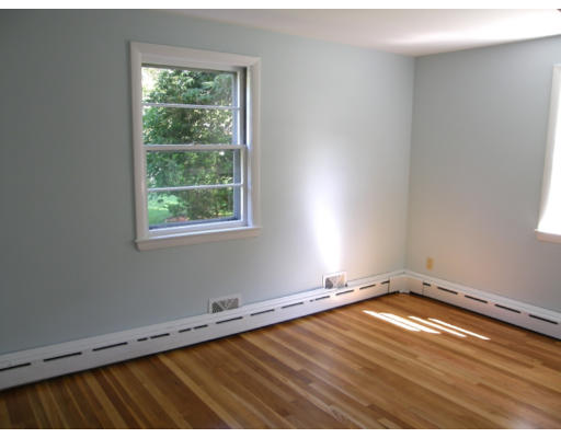 34 Webster Road Lexington, MA 02421 - Photo 8 of 12 an empty room with wooden floor and windows
