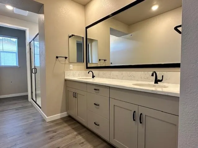 a bathroom with a double vanity sink mirror and
