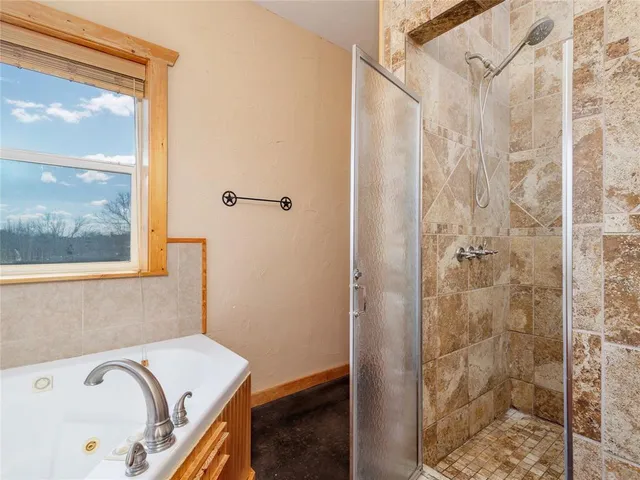 a bathroom with a tub and shower