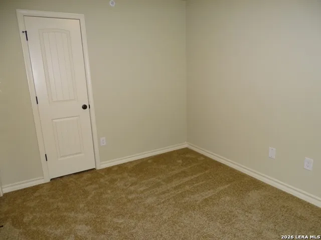 an empty room with closet area