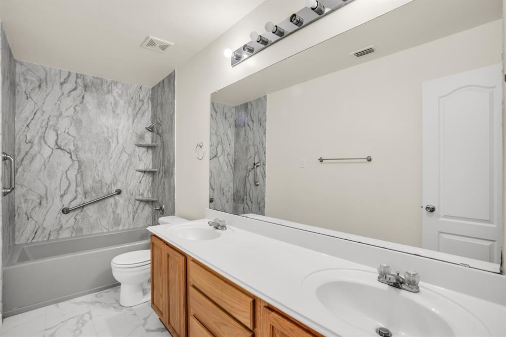 2005 Ridgeview Court Sanger, TX 76266 - Photo 15 of 20 a bathroom with a sink a toilet and shower