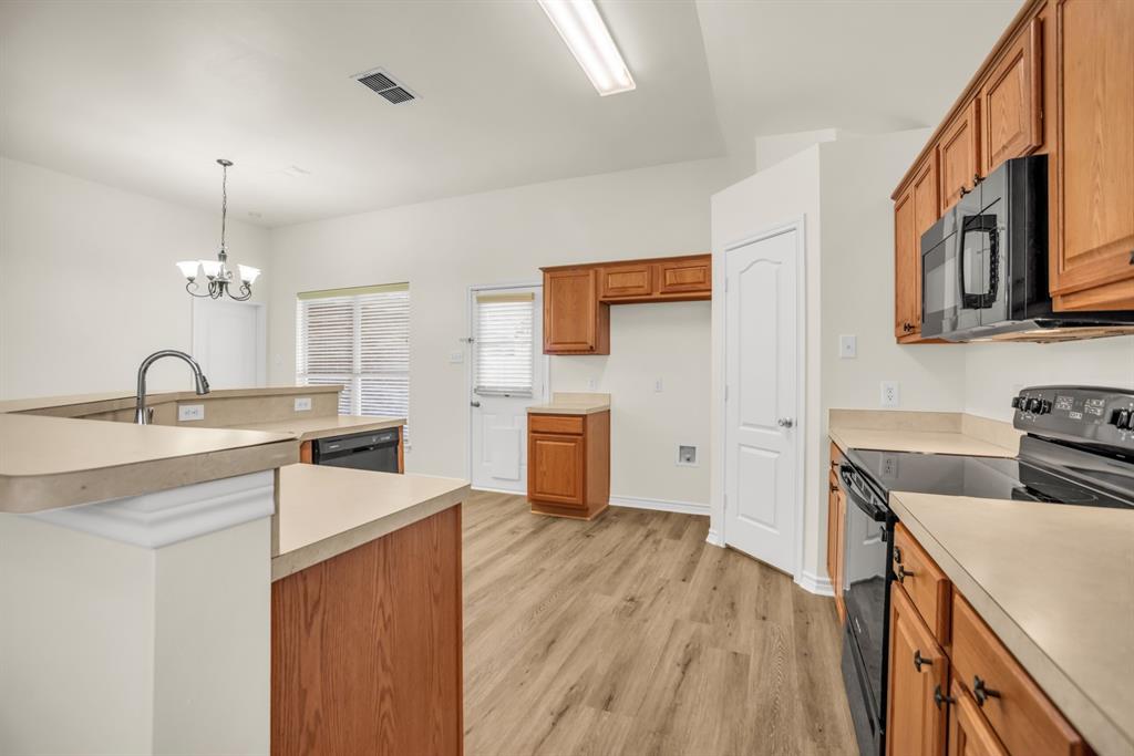 2005 Ridgeview Court Sanger, TX 76266 - Photo 5 of 20 a kitchen with granite countertop a sink and a stove top oven