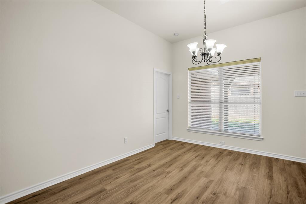 2005 Ridgeview Court Sanger, TX 76266 - Photo 6 of 20 a view of empty room with wooden floor and window