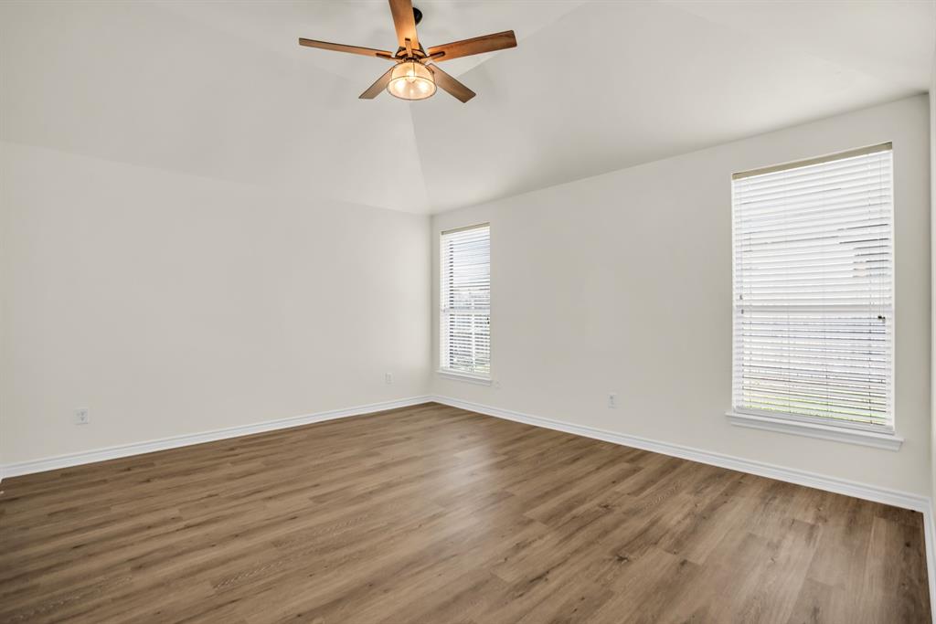 2005 Ridgeview Court Sanger, TX 76266 - Photo 7 of 20 an empty room with wooden floor fan and windows