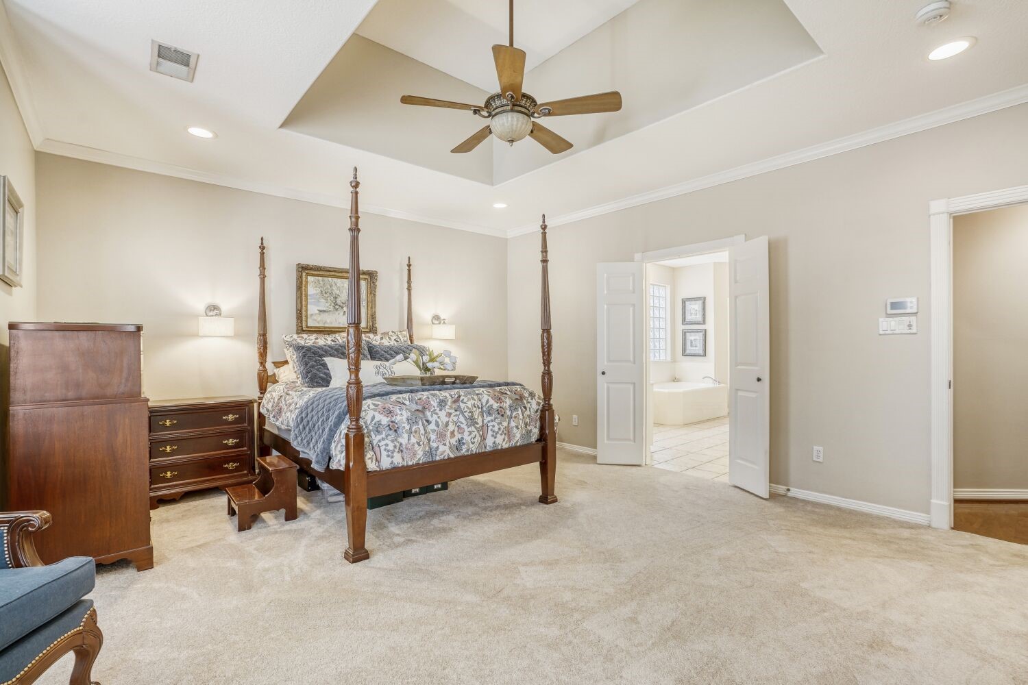 5308 Mountain Grove Court Spring, TX 77379 - Photo 14 of 31 The primary also offers a tray ceiling and recessed lighting. Double doors lead to an en-suite bathroom, enhancing the room's luxury and functionality.