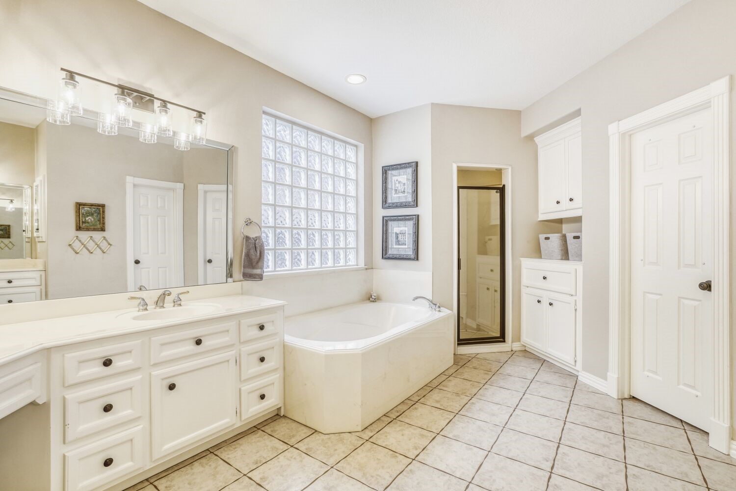 5308 Mountain Grove Court Spring, TX 77379 - Photo 16 of 31 This spacious and elegant primary bathroom features a luxurious soaking tub, a separate glass-enclosed shower, dual sinks with generous counter space, and an adjacent large walk-in closet.