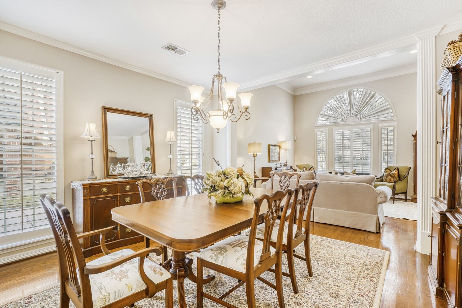 5308 Mountain Grove Court Spring, TX 77379 - Photo 18 of 31 This elegant dining and living area features hardwood floors, large windows with shutters, and a stylish chandelier. The space is bright and open, perfect for entertaining or family gatherings.