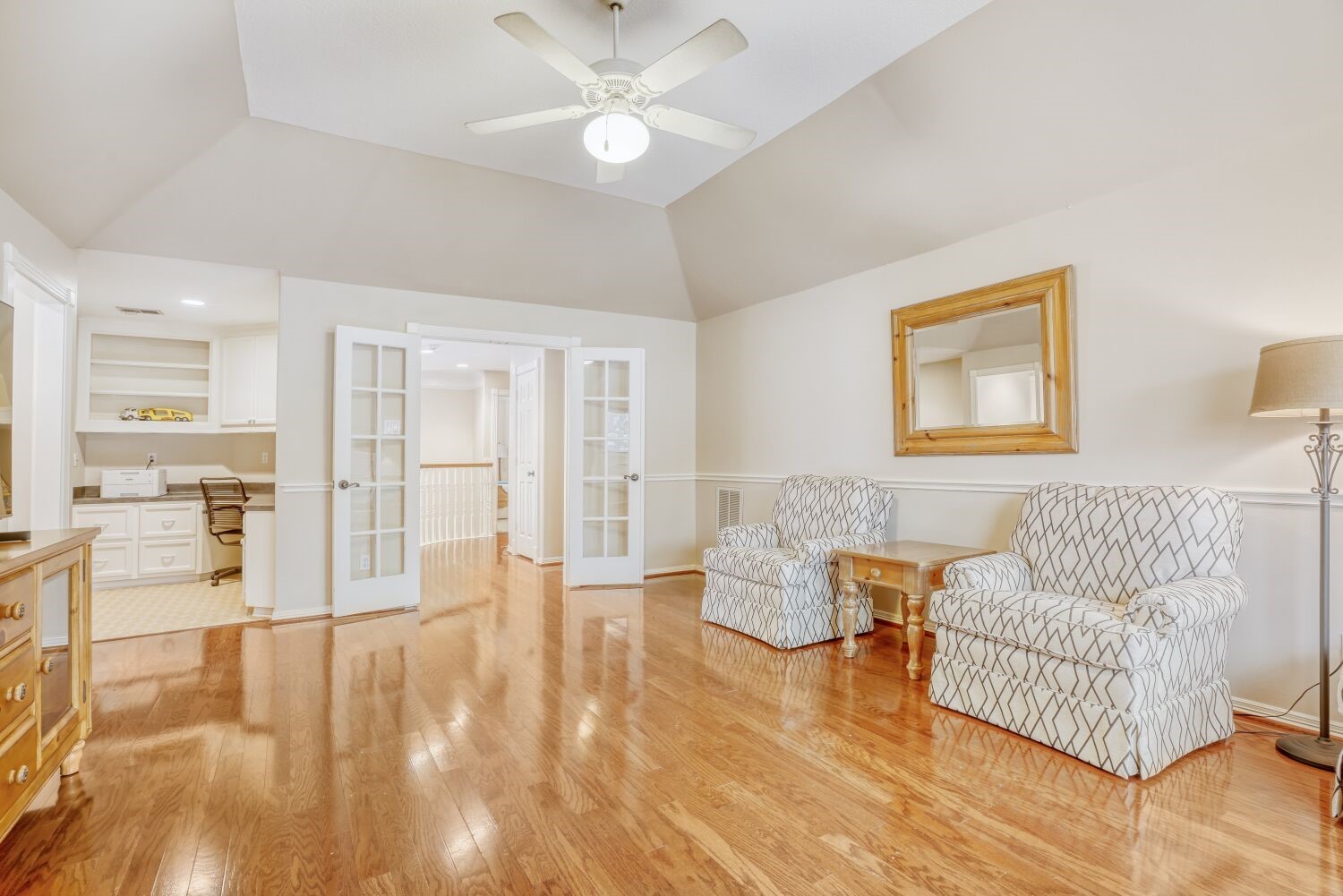 5308 Mountain Grove Court Spring, TX 77379 - Photo 25 of 31 Inside, french doors open to a home office space with built-in shelving and a desk, creating a functional environment.