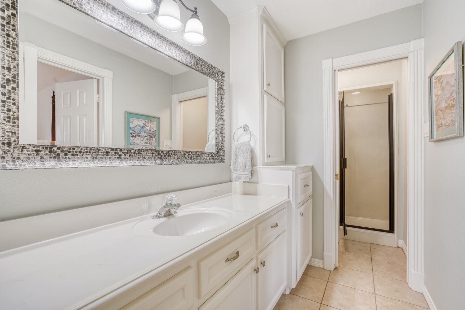 5308 Mountain Grove Court Spring, TX 77379 - Photo 30 of 31 This en-suite bathroom features a spacious countertop with a large mirror, modern lighting, ample cabinet storage, with a walk-in shower.