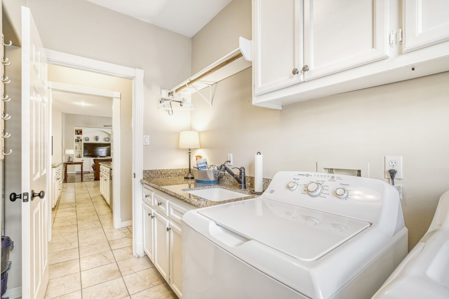 5308 Mountain Grove Court Spring, TX 77379 - Photo 31 of 31 This bright and well-appointed laundry room features granite countertops, abundant cabinet storage, and a convenient sink and drying rack.