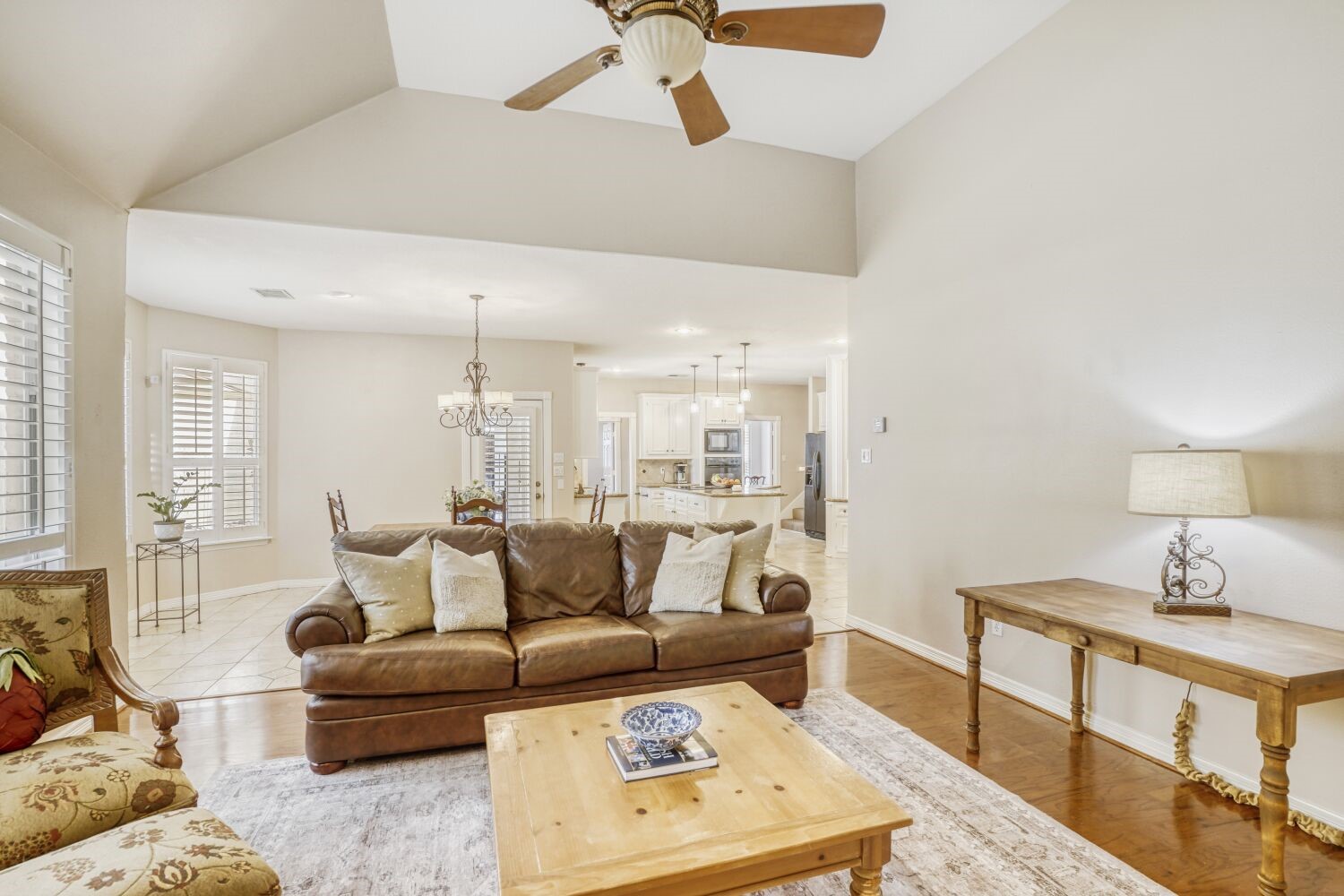 5308 Mountain Grove Court Spring, TX 77379 - Photo 8 of 31 This photo shows the spacious living area with high ceilings and large windows to provide plenty of natural light. The open layout leads into a dining area and modern kitchen, creating a warm and inviting atmosphere.