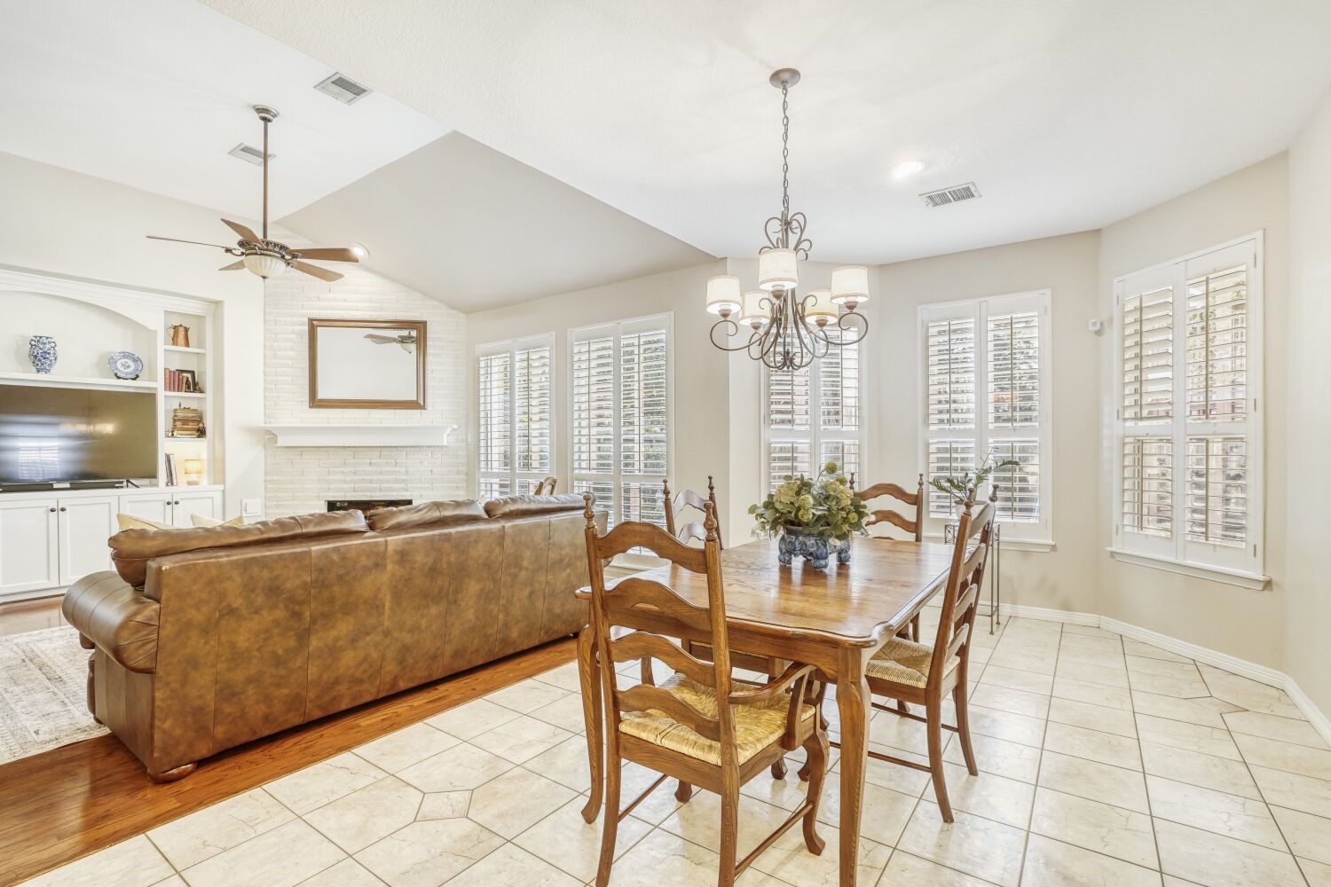 5308 Mountain Grove Court Spring, TX 77379 - Photo 9 of 31 The dining area is accented by a stylish chandelier and classic white shutters, creating a bright, inviting space that opens to the living and kitchen areas—ideal for casual meals and morning coffee.