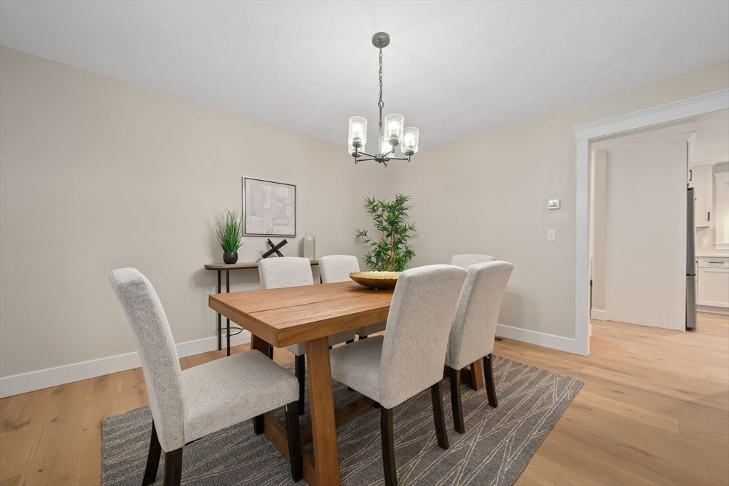 27 Caleb Drive Middleboro, MA 02346 - Photo 12 of 42 a view of a dining room with furniture a chandelier and wooden floor