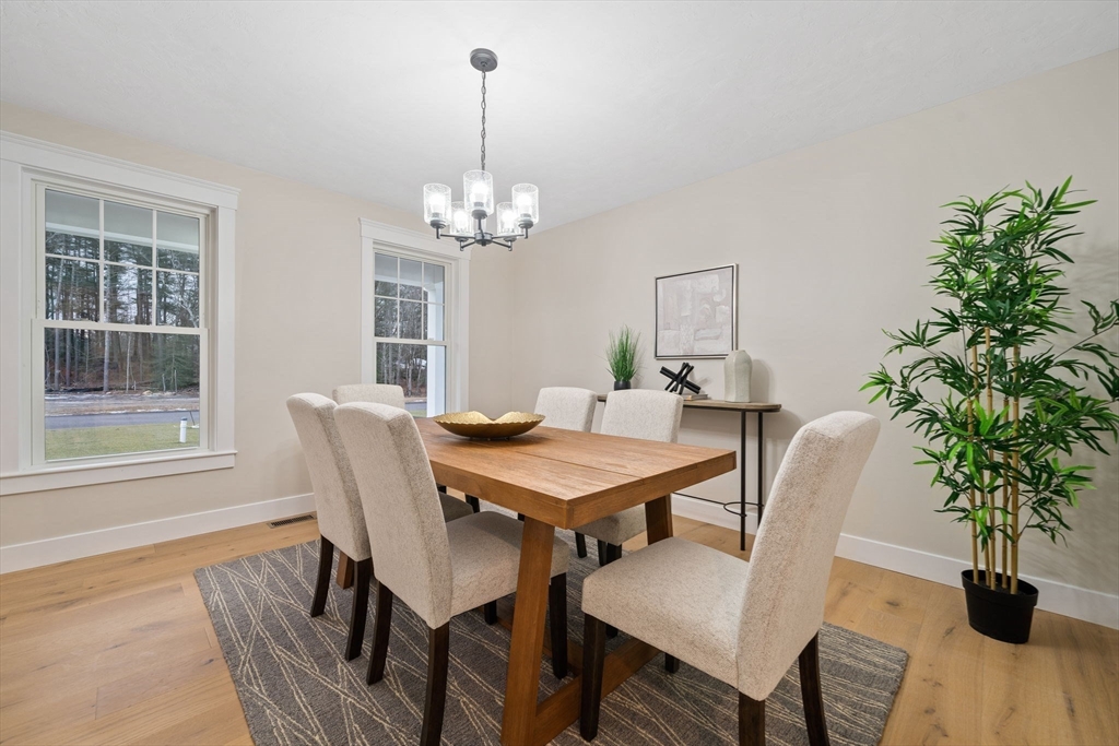 27 Caleb Drive Middleboro, MA 02346 - Photo 13 of 42 a view of a dining room with furniture window and wooden floor