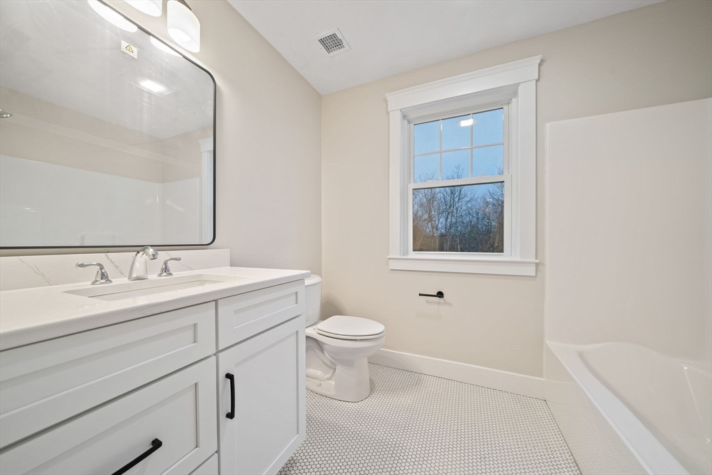 27 Caleb Drive Middleboro, MA 02346 - Photo 26 of 42 a bathroom with a toilet a sink a mirror and a bathtub