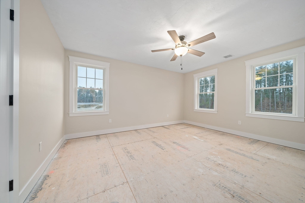 27 Caleb Drive Middleboro, MA 02346 - Photo 27 of 42 an empty room with windows and fan