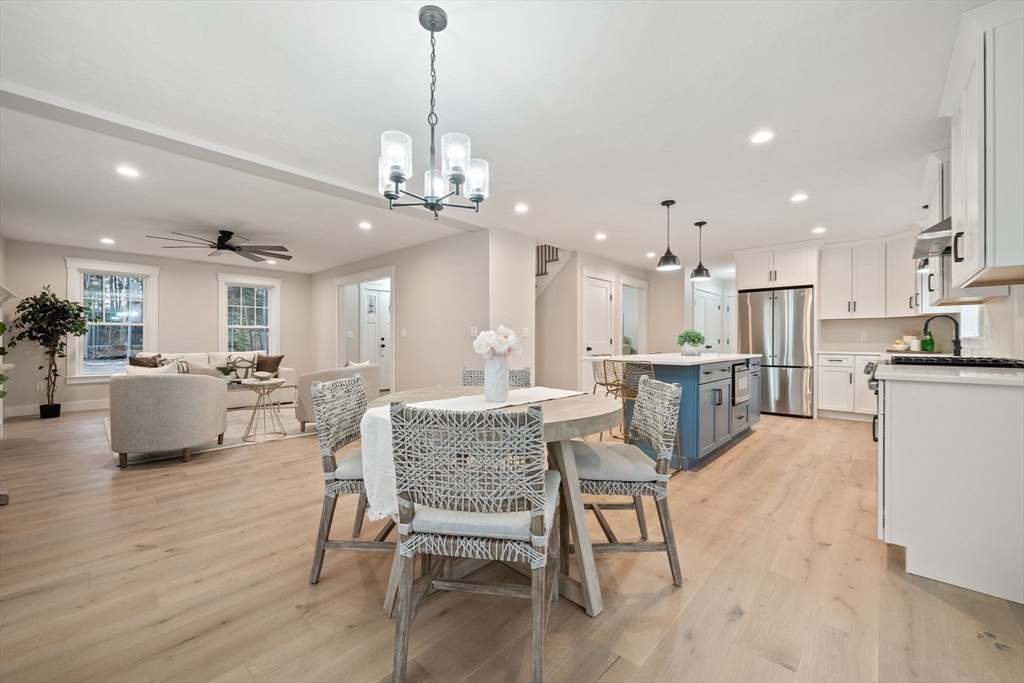 27 Caleb Drive Middleboro, MA 02346 - Photo 8 of 42 a view of a dining room and livingroom with furniture wooden floor a chandelier