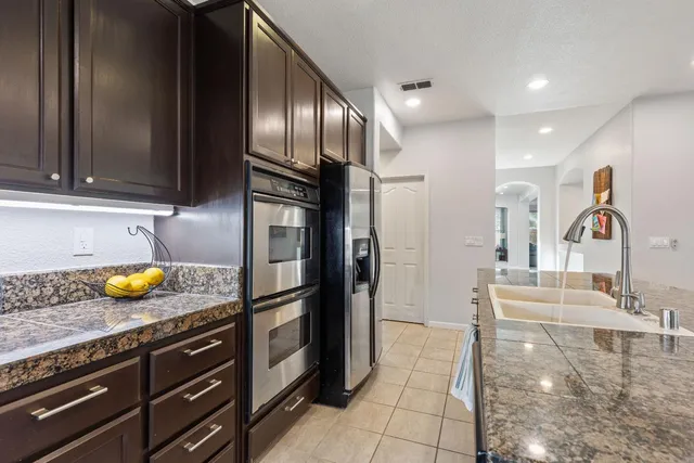 a kitchen with a sink and refrigerator