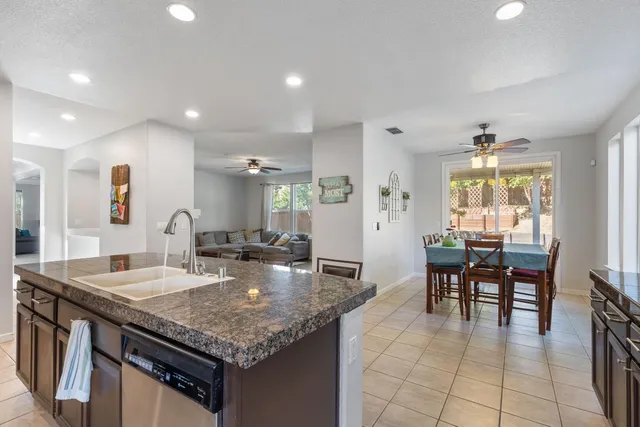 a kitchen with center island table and chairs in it