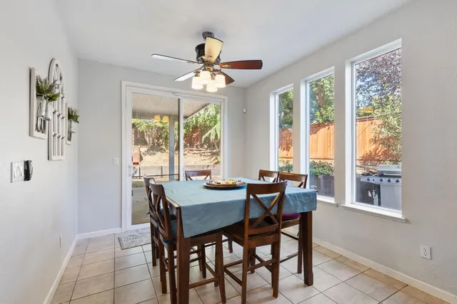a dining room with furniture a chandelier and a rug
