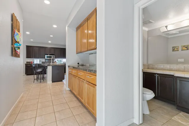 a kitchen with stainless steel appliances kitchen island granite countertop a sink and cabinets