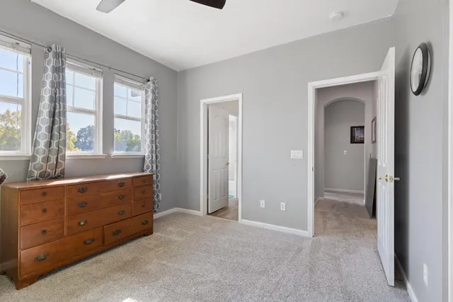 a view of a hallway with a livingroom and furniture