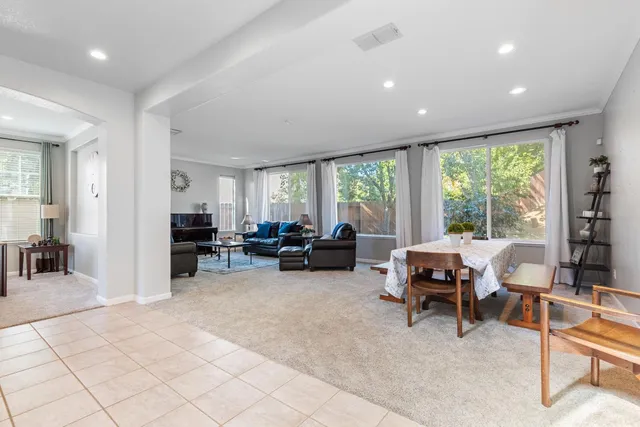 a living room with furniture and large windows