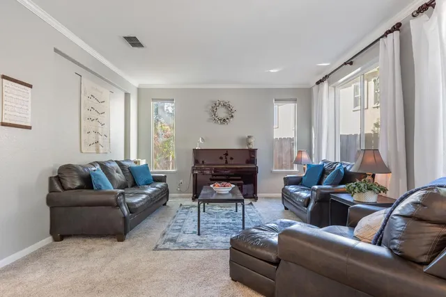 a living room with furniture a large window and a fireplace