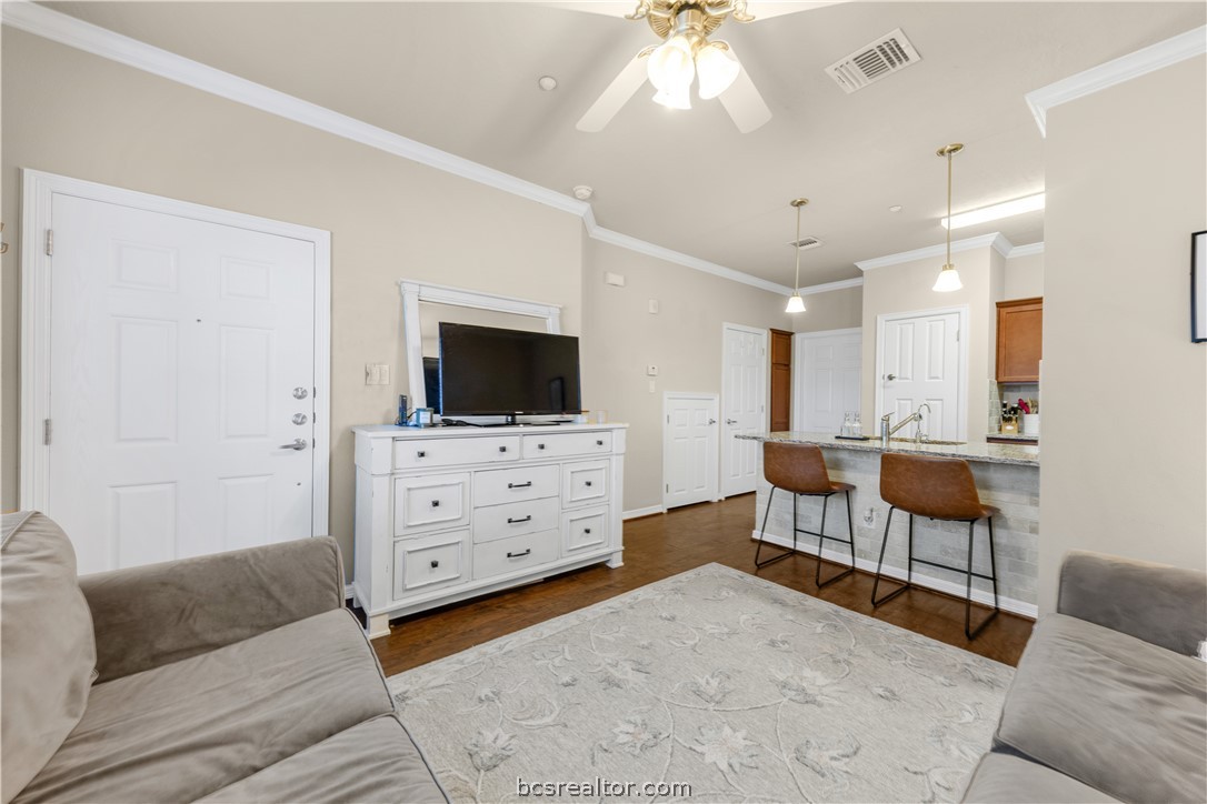 1198 Jones-Butler Road, Unit 1403 College Station, TX 77840 - Photo 4 of 20 a living room with furniture and a flat screen tv