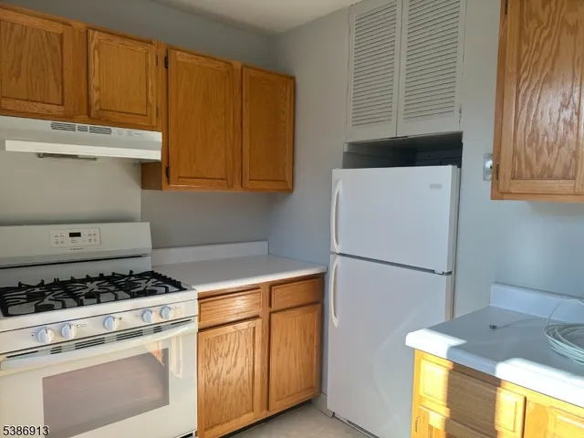 a kitchen with a white stove top oven and sink