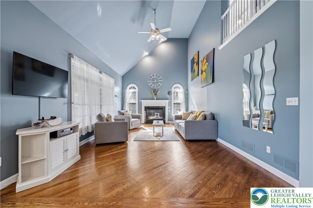 13 Country Road Northampton, PA 18067 - Photo 29 of 71 Vast vaulted ceilings complement rich hardwood floors, creating an airy living space with a grand fireplace as its focal point.