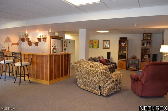 7608 Dewey Road Thompson, OH 44086 - Photo 19 of 25 Lower level rec room with newer carpeting, wet bar, full bath and coal/wood burner for those cozy winter nights.