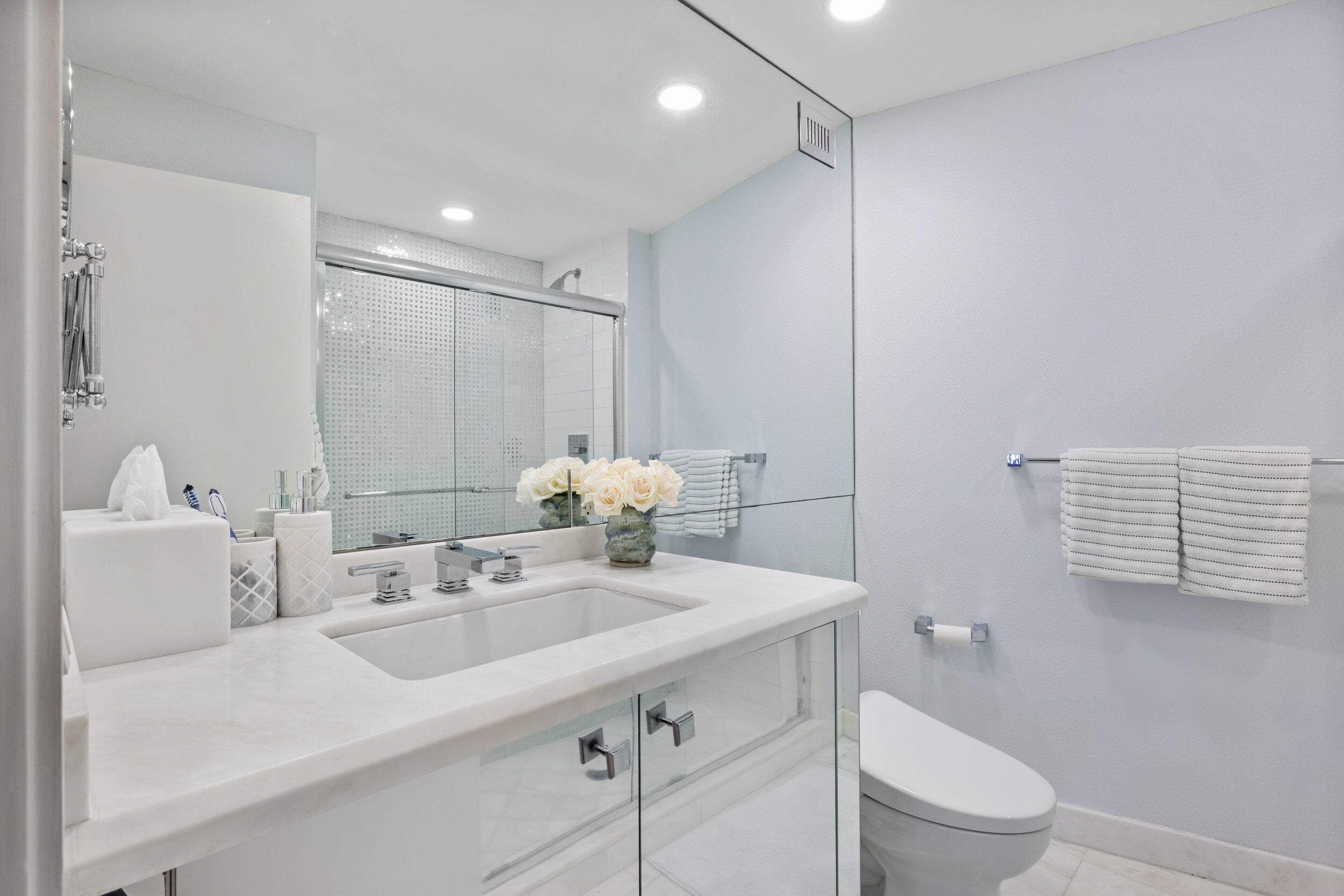 44 Cocoanut Row, Unit 510/511 B Palm Beach, FL 33480 - Photo 11 of 24 a bathroom with a sink a toilet and a mirror