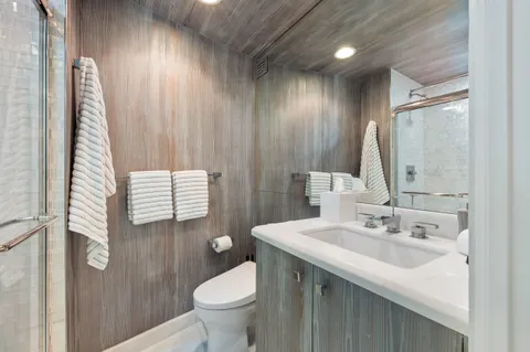 a bathroom with a sink toilet and shower
