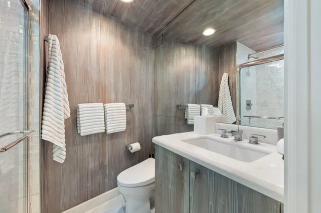 a bathroom with a sink toilet and shower