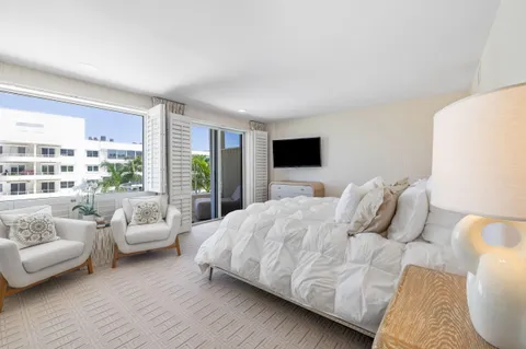 a bedroom with furniture and a flat screen tv