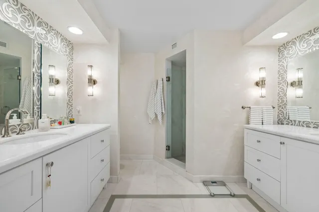a bathroom with a shower sink and mirror