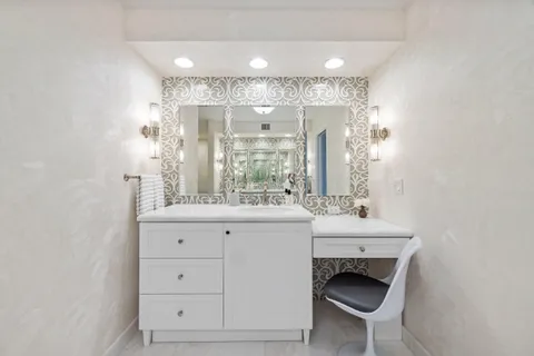 a bathroom with a sink a toilet and mirror