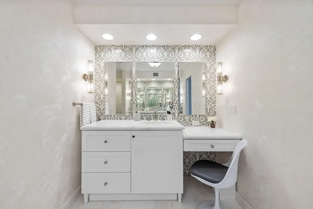 a bathroom with a sink a toilet and mirror